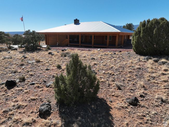 Rear view of property featuring a chimney and metal roof | Image 9