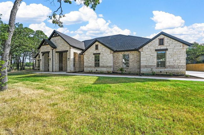 French country inspired facade featuring roof with shingles and a front yard | Image 4