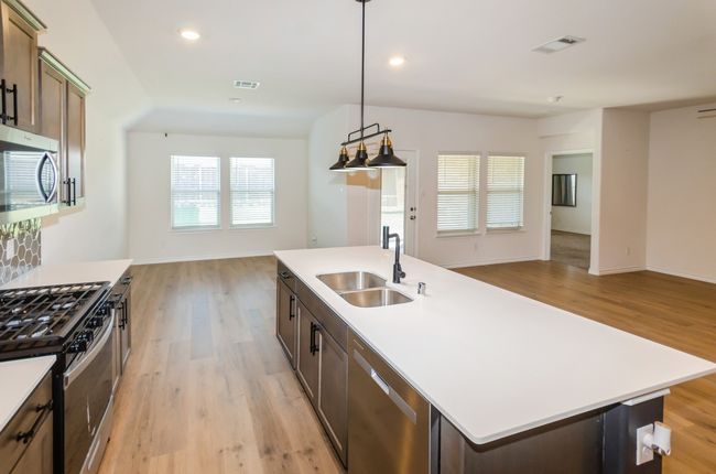 Kitchen featuring a sink, stainless steel appliances, open floor plan, light wood-style floors, and recessed lighting | Image 4