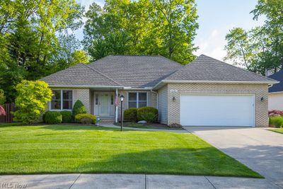 View of front of house with a garage and a front yard | Image 1