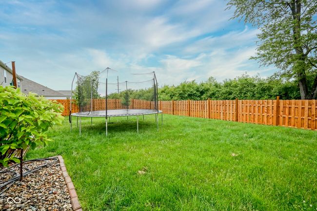 view of yard featuring a trampoline | Image 9