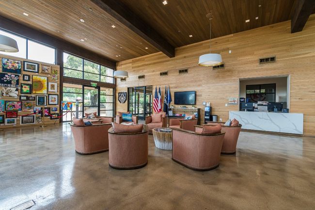 Building lobby featuring wooden walls, a towering ceiling, wooden ceiling, and recessed lighting | Image 29