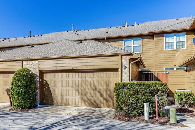 View of front of home featuring roof with shingles, an attached garage, concrete driveway, and brick siding | Image 29