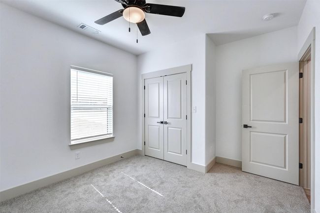 Unfurnished bedroom featuring a closet, baseboards, carpet floors, visible vents, and ceiling fan | Image 13
