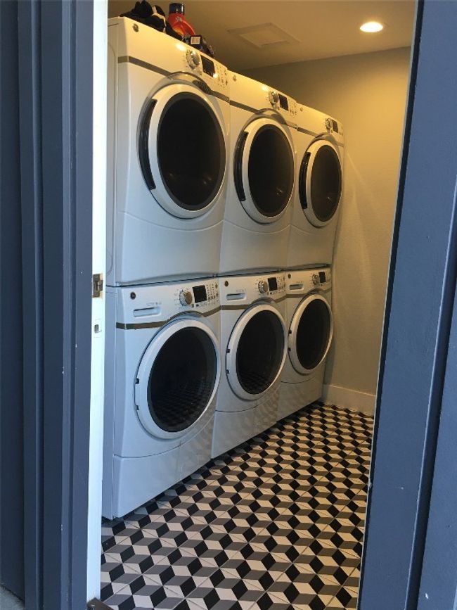 Laundry room with washer and dryer, tile patterned floors, and stacked washer / dryer | Image 14