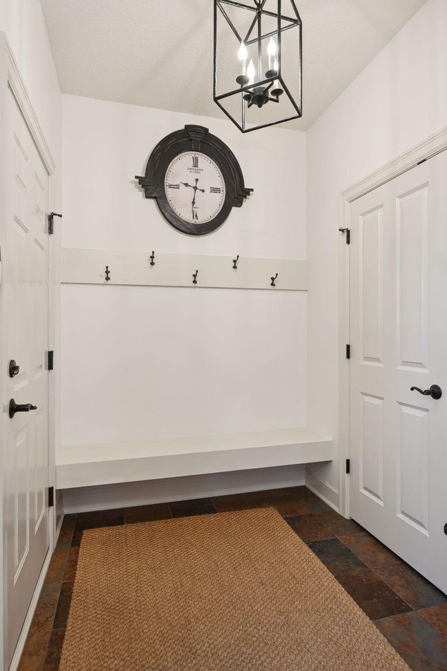 Main floor mud room with built in bench and large closet. | Image 70