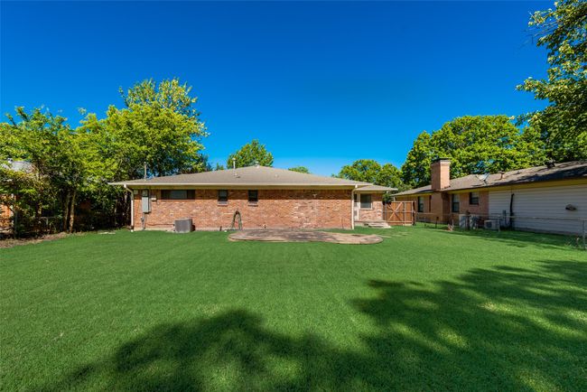 View of yard with cooling unit, fence, and a patio | Image 25