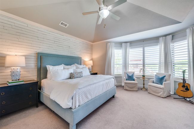 Primary bedroom has vaulted ceiling and bay sitting area for ample room. Take note of the plantation shutters leading to a perfect view of the private back yard. | Image 17