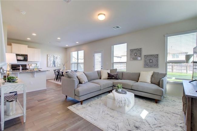 Living area featuring healthy amount of natural light, wood finished floors, and recessed lighting | Image 4