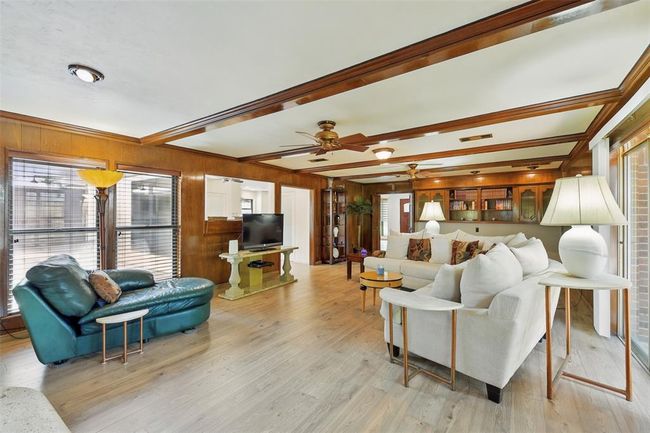 A view from the den looking back towards the entry and kitchen area. | Image 11