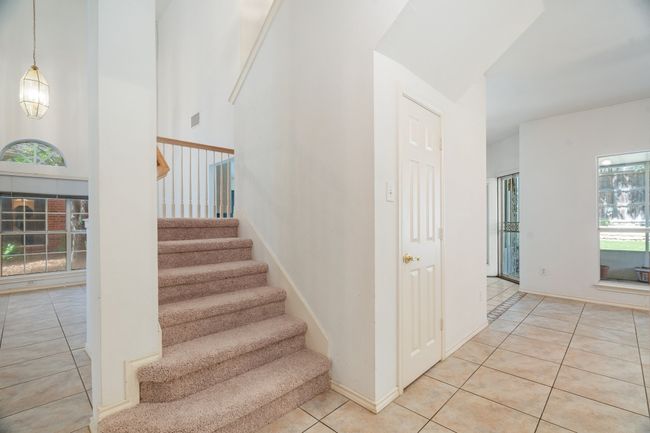 Stairs featuring visible vents, tile patterned floors, and baseboards | Image 7