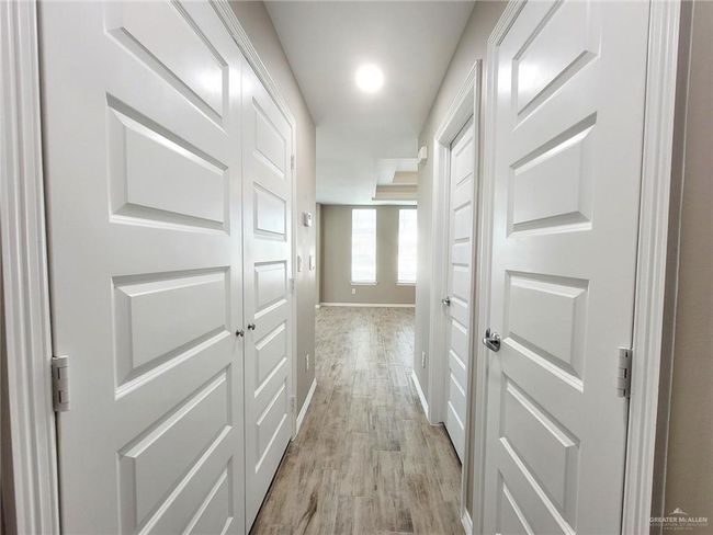 Hall featuring light wood finished floors and baseboards | Image 11