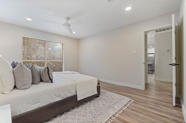 Bedroom with light wood-style floors, recessed lighting, visible vents, and baseboards | Image 22