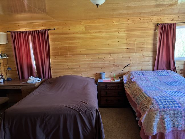 Bedroom featuring wood walls and carpet floors | Image 4