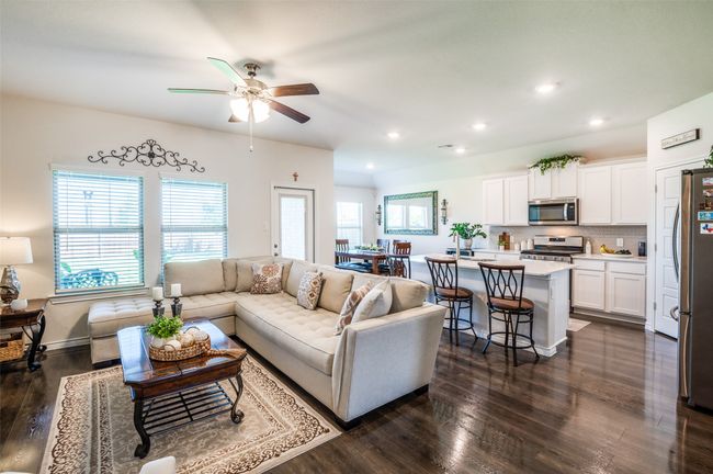 Living area with dark wood-style flooring, recessed lighting, and ceiling fan | Image 6
