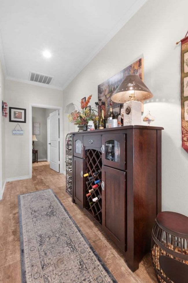 Bar with visible vents, crown molding, and baseboards | Image 18