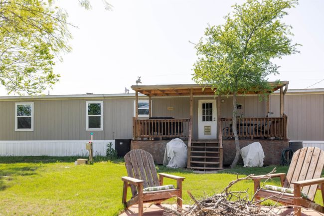 Back of house featuring a lawn and covered porch | Image 27