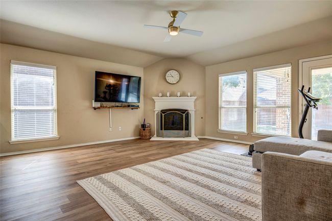 Living room with baseboards, a ceiling fan, and wood finished floors | Image 24