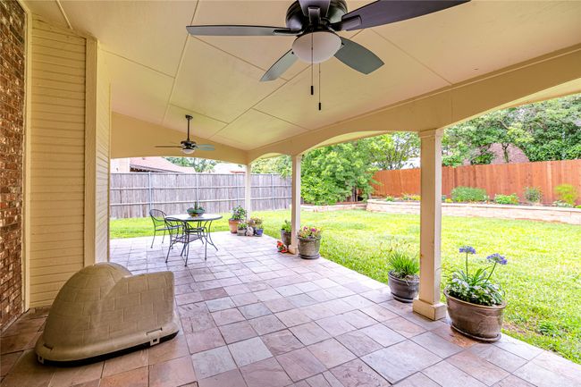 View of patio with outdoor dining area and a ceiling fan | Image 35