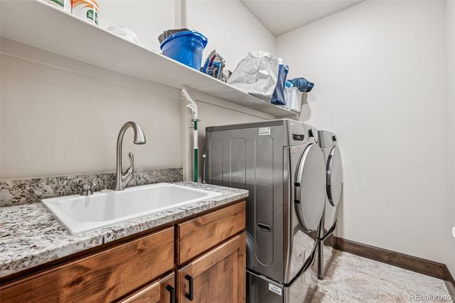 Main Level Laundry room with sink and shelves | Image 28