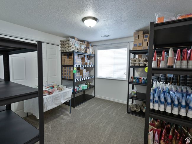 Bedroom with carpet flooring, a textured ceiling, and baseboards | Image 41
