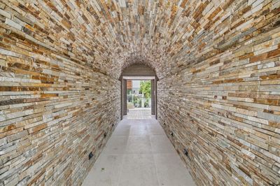 The vaulted passageway is clad with Virginia granite designed by Lighting Unlimited. | Image 3