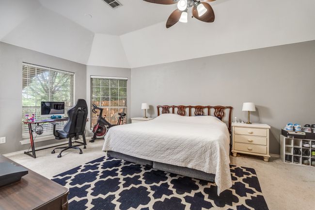 Bedroom with light carpet, vaulted ceiling, an office area, and a ceiling fan | Image 24