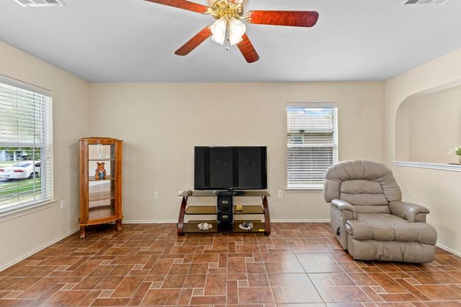 Sitting room featuring a ceiling fan and baseboards | Image 7