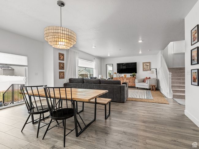 Dining space featuring wood finished floors, stairway, and recessed lighting | Image 11