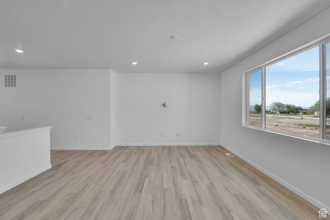 Spare room with light wood-type flooring, healthy amount of natural light, and recessed lighting | Image 26