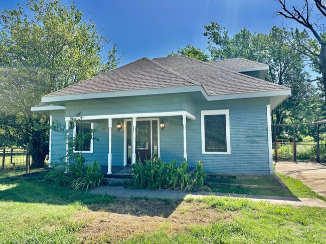 View of front of house with covered porch and a shingled roof | Image 25