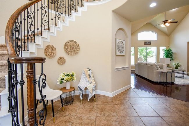 From the entry, the home invites you deeper into the layout, with the living area unfolding just beyond the staircase—offering a preview of the open, interconnected spaces ahead. | Image 10