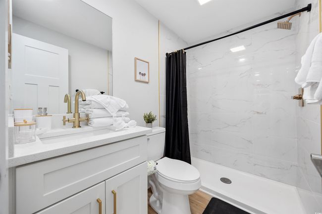 Full bath with vanity, toilet, a shower with shower curtain, and wood finished floors | Image 38