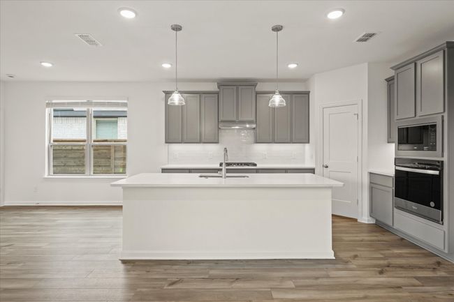 Kitchen with appliances with stainless steel finishes, gray cabinets, light countertops, and recessed lighting | Image 15