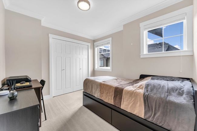 Bedroom featuring light colored carpet, crown molding, and a closet | Image 15