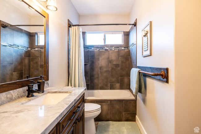 Full bath featuring vanity and shower / bath combination with curtain | Image 65