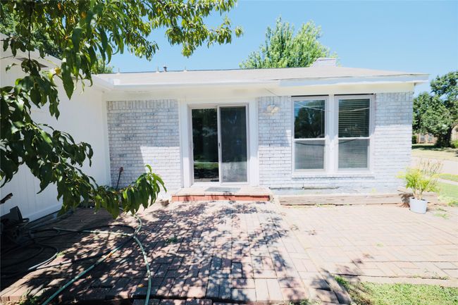 Rear view of property featuring brick siding and a patio | Image 32