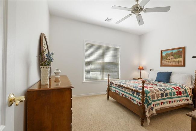 Bedroom with ceiling fan, baseboards, carpet, and visible vents | Image 36