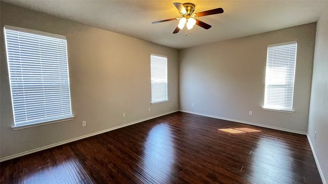 Spare room with ceiling fan and dark wood-style flooring | Image 16