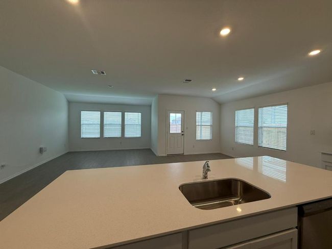 Kitchen featuring a sink, open floor plan, dishwasher, light countertops, and recessed lighting | Image 22