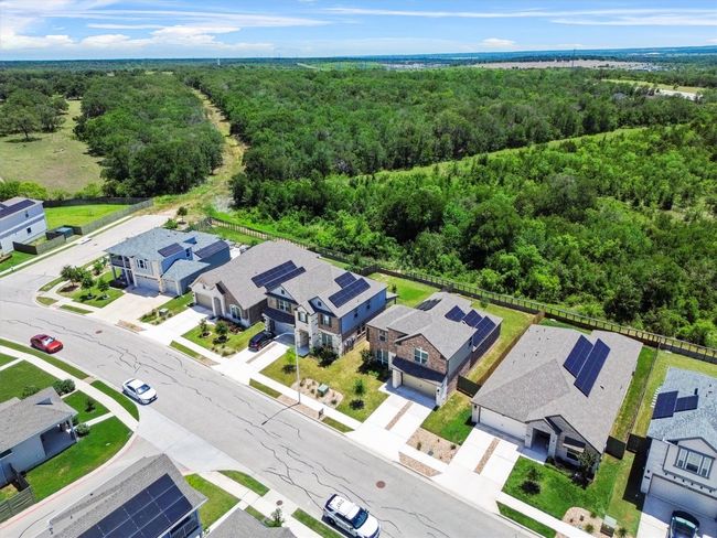 Aerial view of residential area with a forest | Image 24