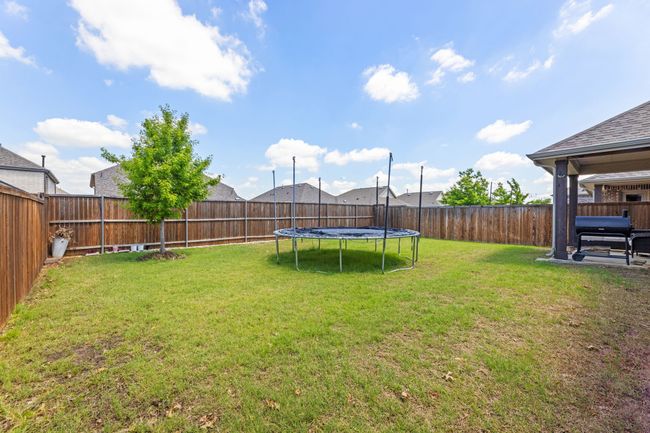 View of yard with a trampoline and a fenced backyard | Image 36