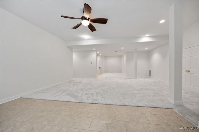 room with a ceiling fan, recessed lighting, and light carpet, and kitchenette. Large mechanical room as in basement. | Image 46