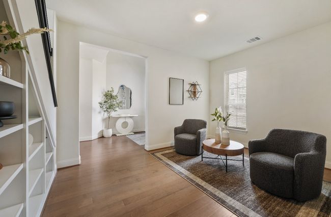 Living area featuring wood finished floors and baseboards | Image 8