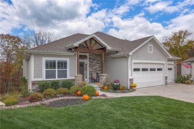 Craftsman-style house with a garage and a front lawn | Image 3