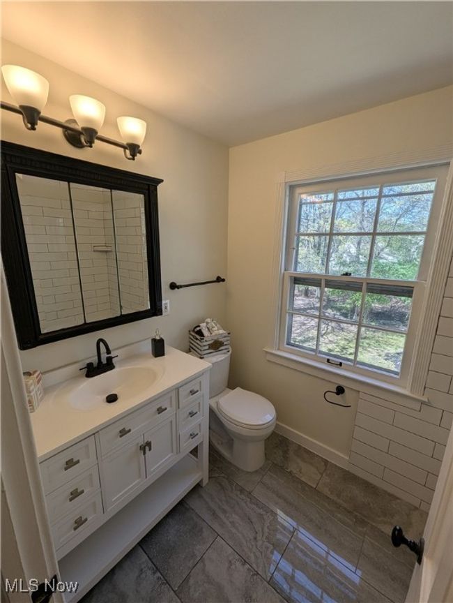 Bathroom featuring toilet and vanity | Image 7