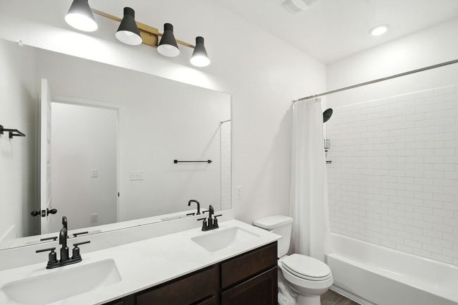 Full bathroom featuring shower / tub combo and a sink | Image 25