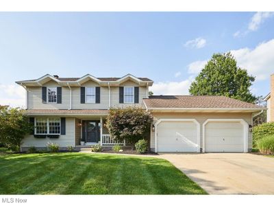 View of property featuring a garage and a front lawn | Image 1