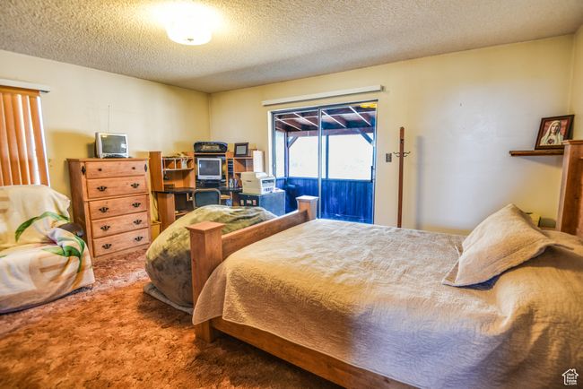 Carpeted bedroom with access to outside and a textured ceiling | Image 18