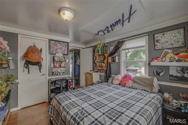 Bedroom featuring wood finished floors and a closet | Image 10